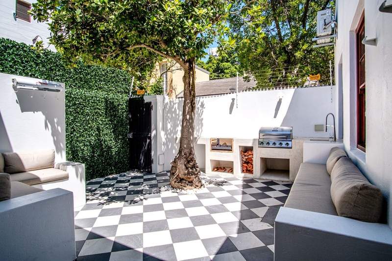 Courtyard renovation with checkerboard tiling and built-in braai