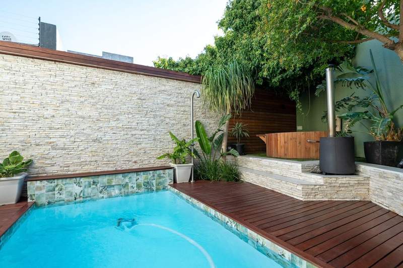 Pool courtyard with stone cladding and timber deck