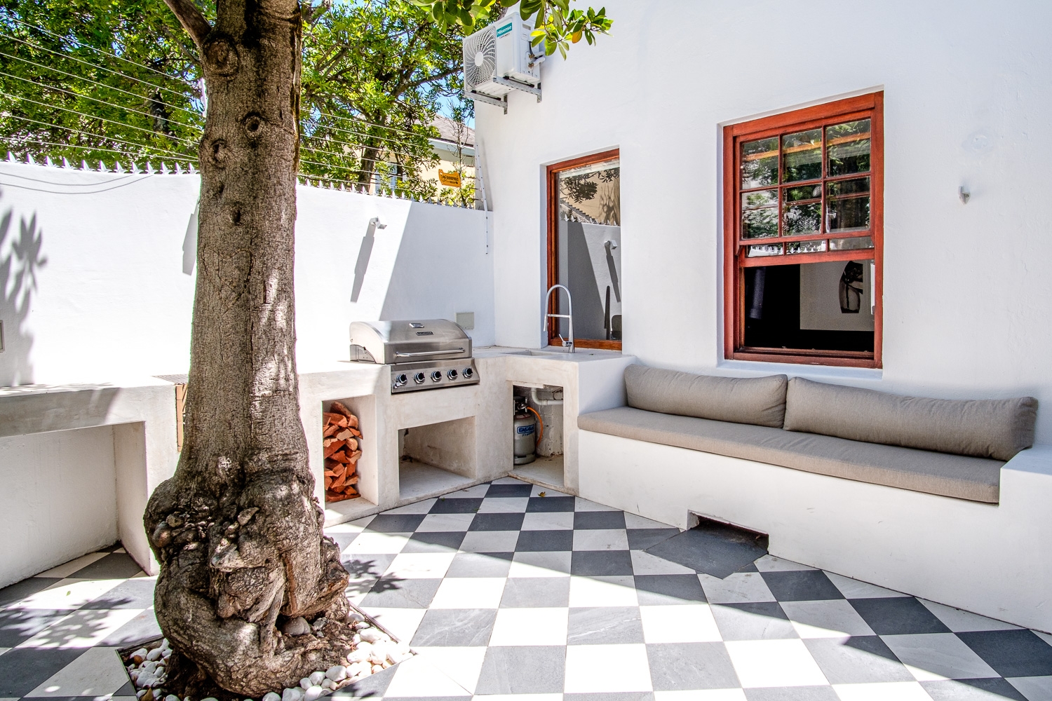 Courtyard with built-in braai, seating and checkerboard tiles
